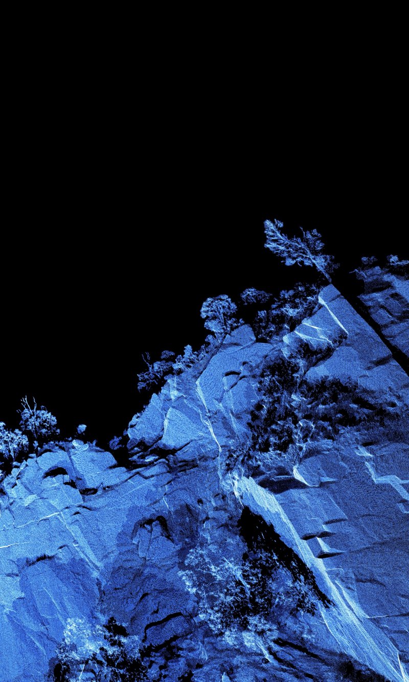 Mountain Quarry C: blue point cloud scan of angled rock slabs and vegetation